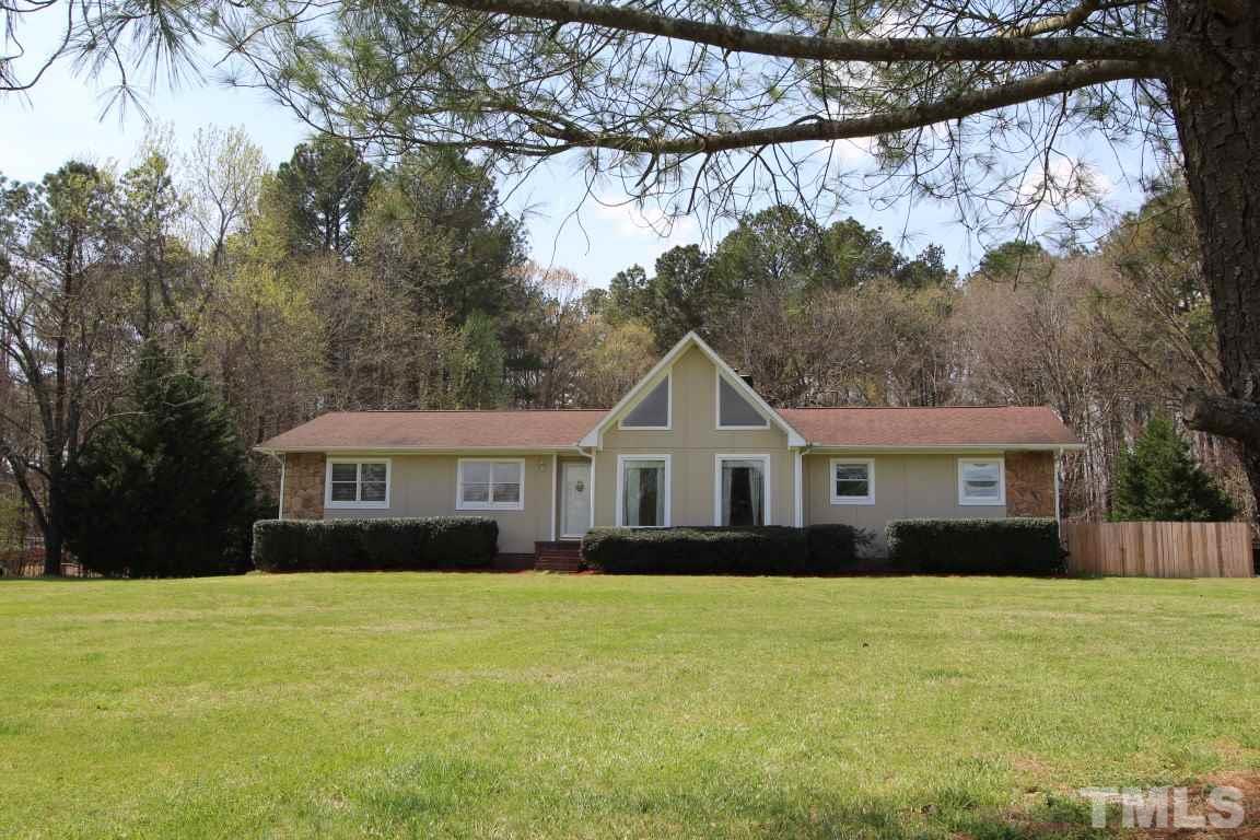 1303 Patterson Road Durham, NC 27704 - Photo 1 of 4 a front view of a house with a garden and trees