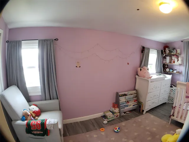 a bedroom with furniture and a window