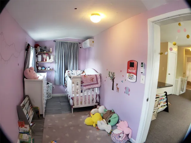 a bed sitting in a bedroom next to a window