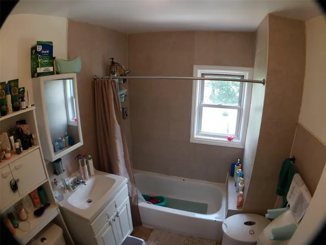 a room with gym equipment and a view of living room