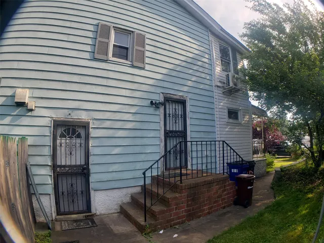 a view of a house with a yard garage and outdoor seating