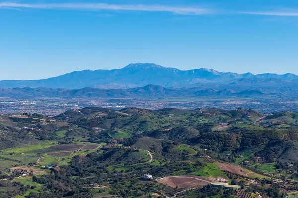 a view of a town with mountains in the background