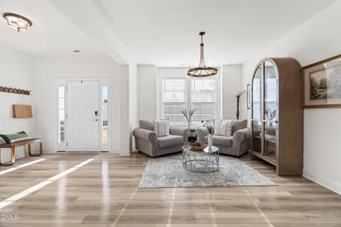 a living room with furniture and a chandelier