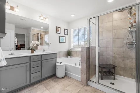 a bathroom with a double vanity sink toilet and shower