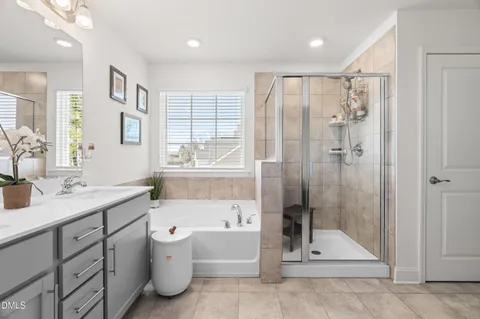 a bathroom with a tub sink toilet and mirror