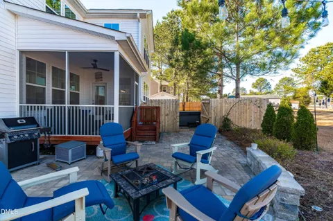a view of a patio with couches table and chairs and potted plants