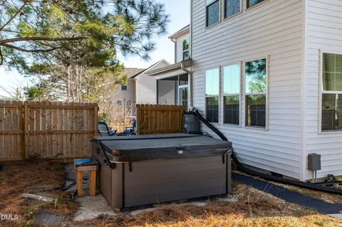 a view of a roof deck with wooden fence and a couple of chairs