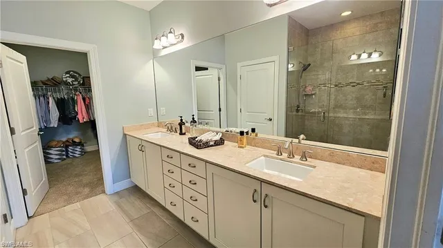 a bathroom with double sink and a mirror