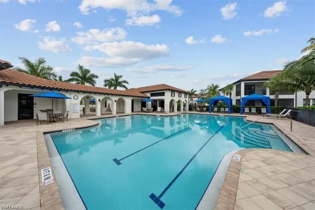 a view of a swimming pool and lounge chairs