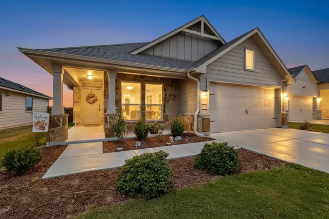 a view of a house with backyard and sitting area