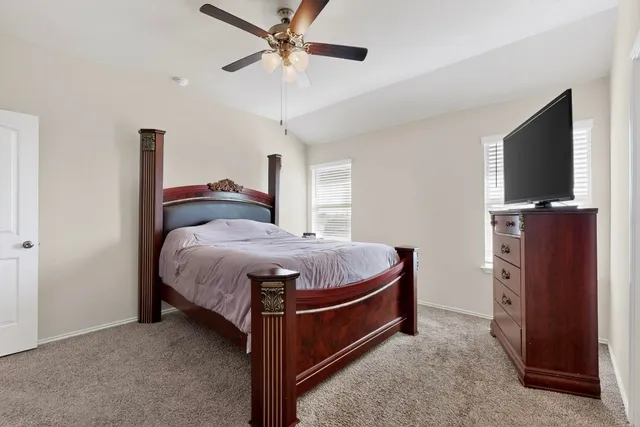 a bed room with a bed and a television