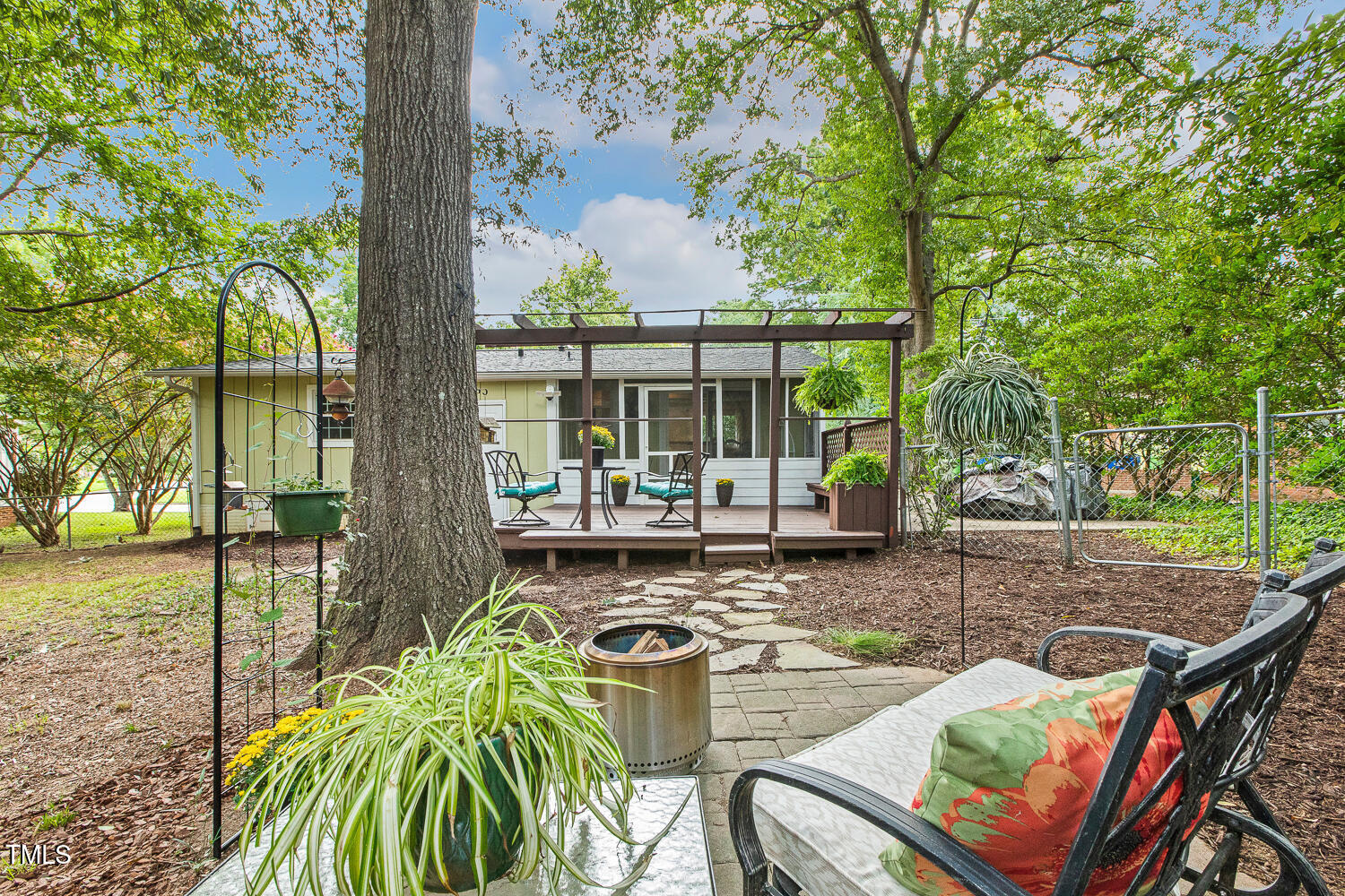 1105 Culpepper Lane Raleigh, NC 27610 - Photo 42 of 46 a view of a patio with table and chairs potted plants and large tree