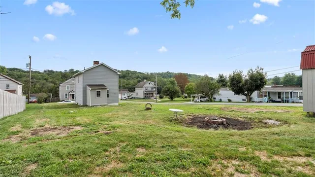 a kitchen with a stove a refrigerator and a white cabinets
