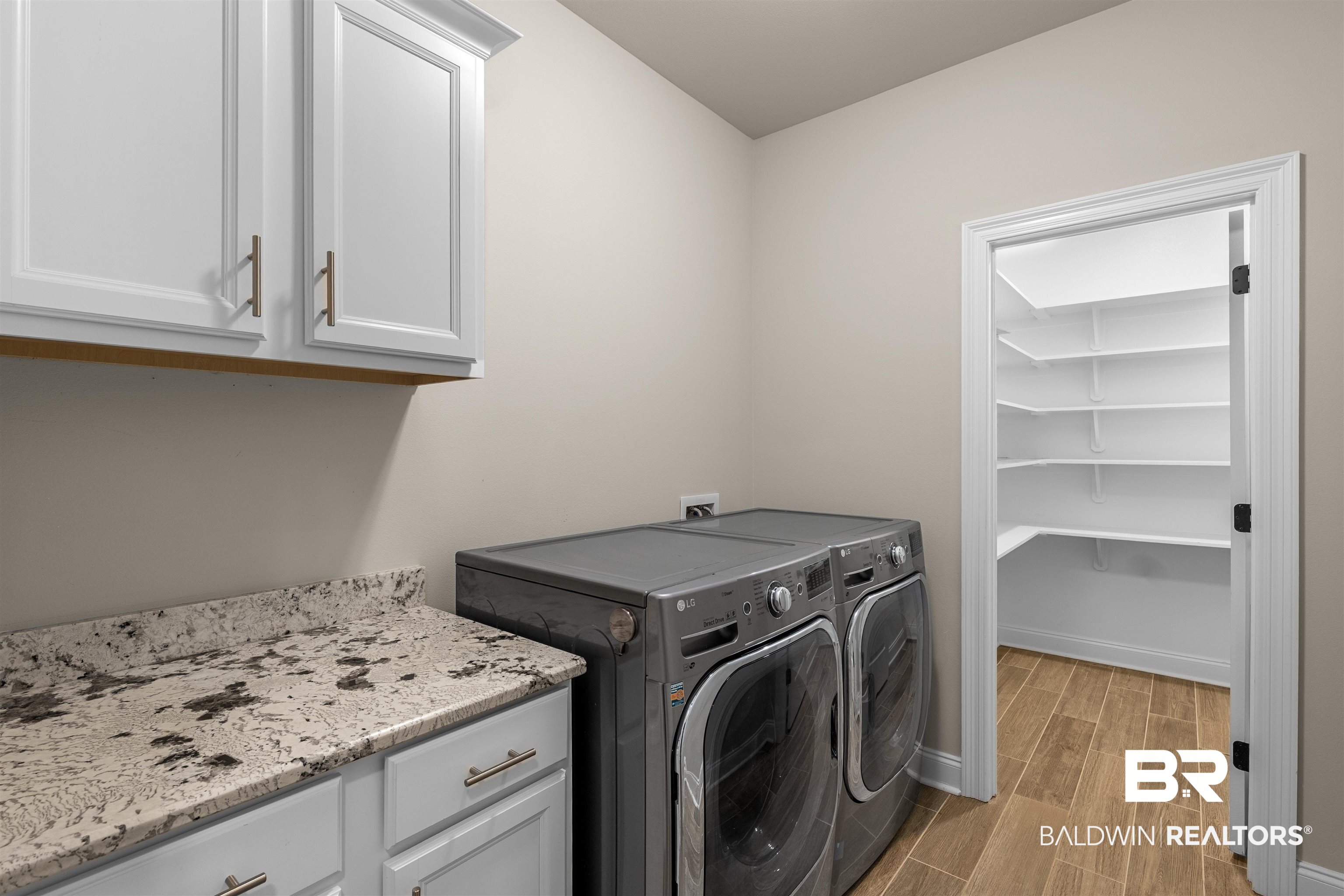 991 Dalton Circle Foley, AL 36535 - Photo 16 of 35 Laundry area with cabinet space, independent washer and dryer, and wood tiled floors