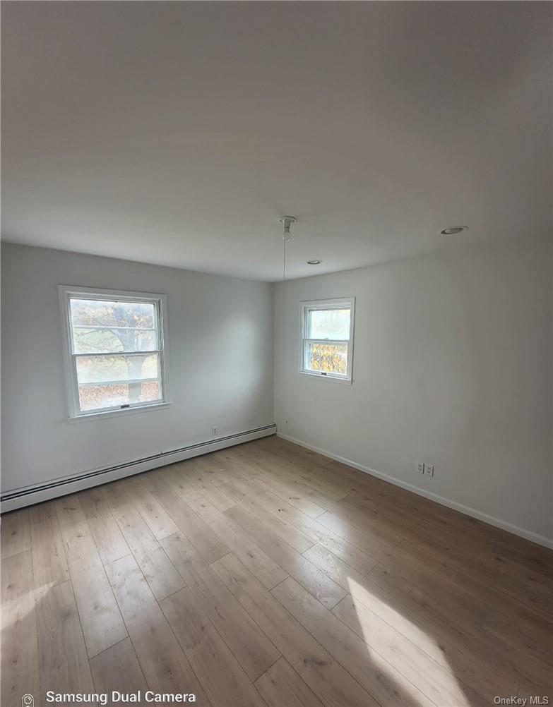 230 Prospect Road Monroe, NY 10950 - Photo 11 of 13 Empty room featuring a baseboard heating unit and light wood-style flooring