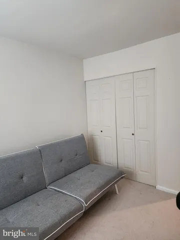 a living room with a couch and a ceiling fan