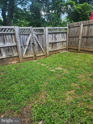 a view of a deck with a sink and wooden fence