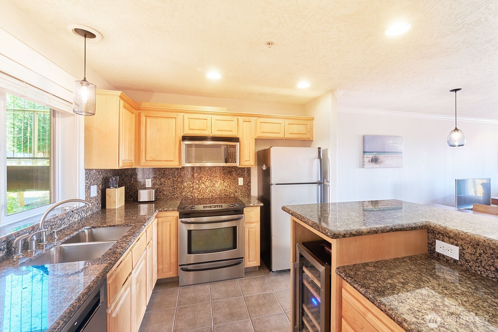 2815 Willows Road, Unit 229 Seaview, WA 98644 - Photo 11 of 25 a kitchen with stainless steel appliances granite countertop a sink stove and refrigerator