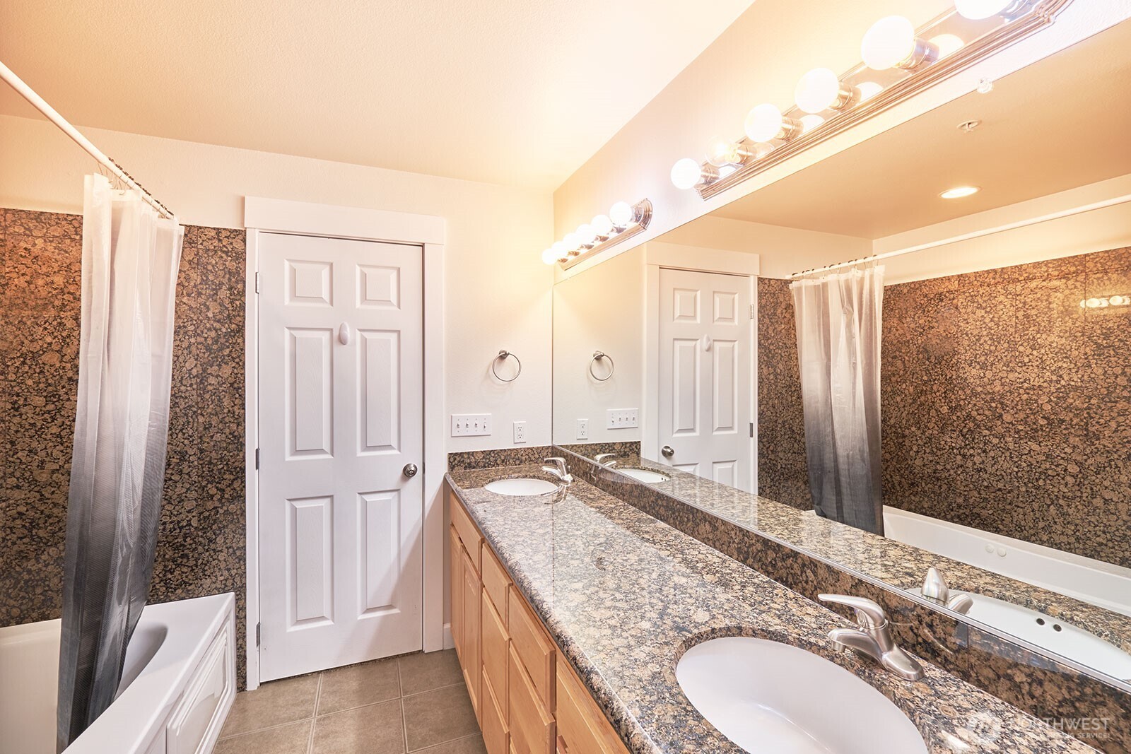 2815 Willows Road, Unit 229 Seaview, WA 98644 - Photo 14 of 25 a bathroom with a granite countertop double vanity sink and mirror