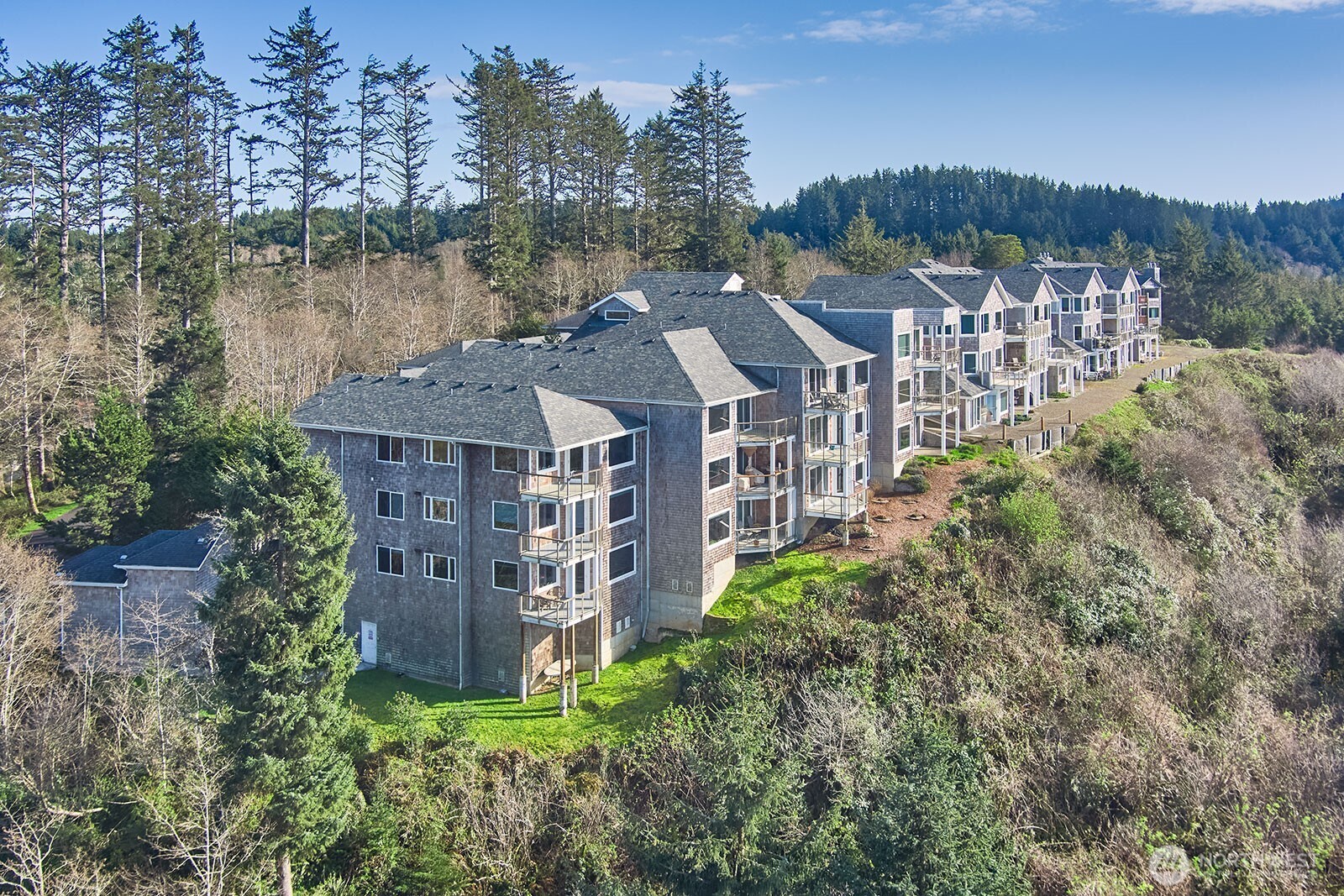 2815 Willows Road, Unit 229 Seaview, WA 98644 - Photo 23 of 25 a view of a brick house with a big yard plants and large trees