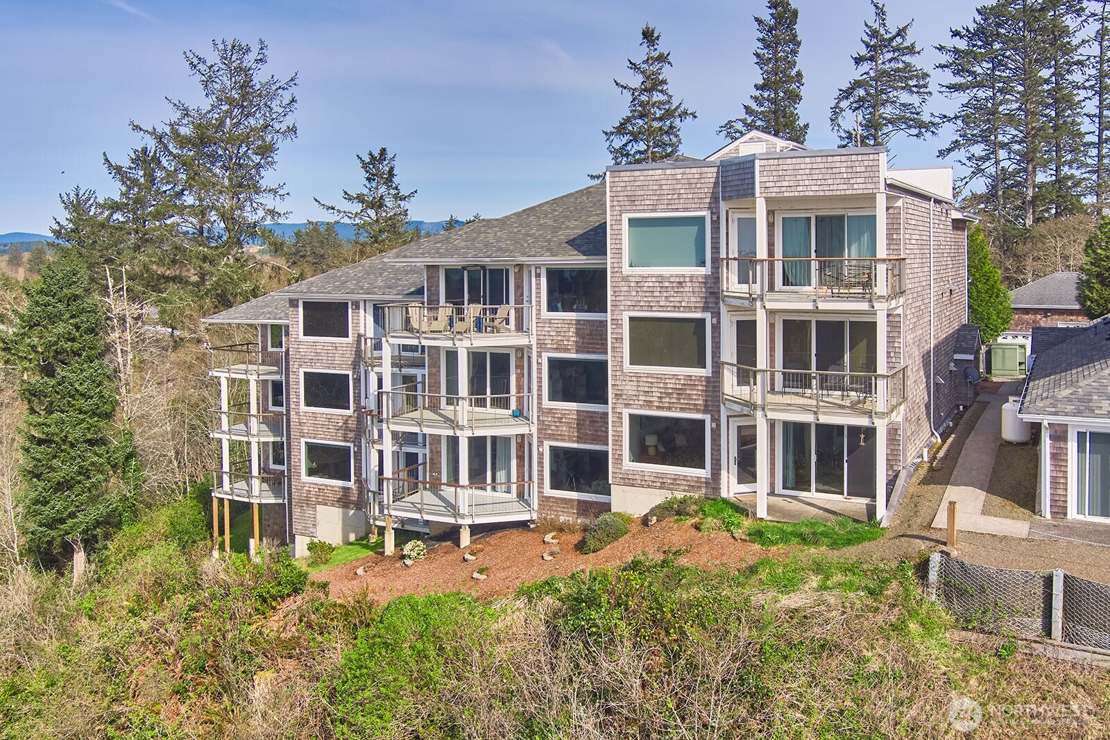 2815 Willows Road, Unit 229 Seaview, WA 98644 - Photo 24 of 25 a front view of a building with a garden