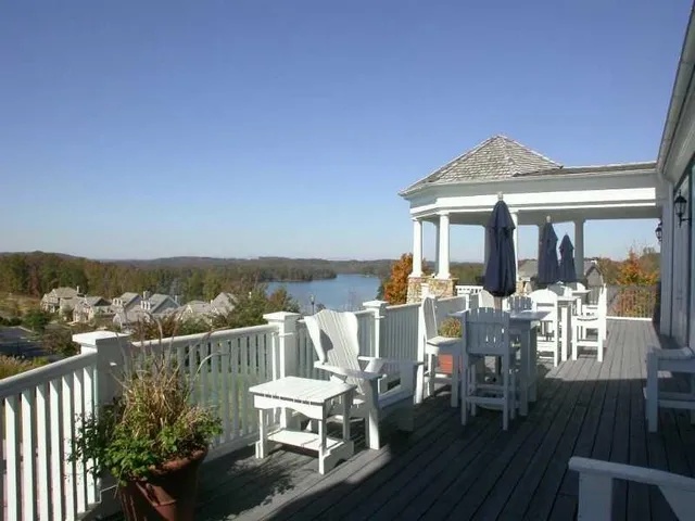 a living room with furniture a fireplace and large windows