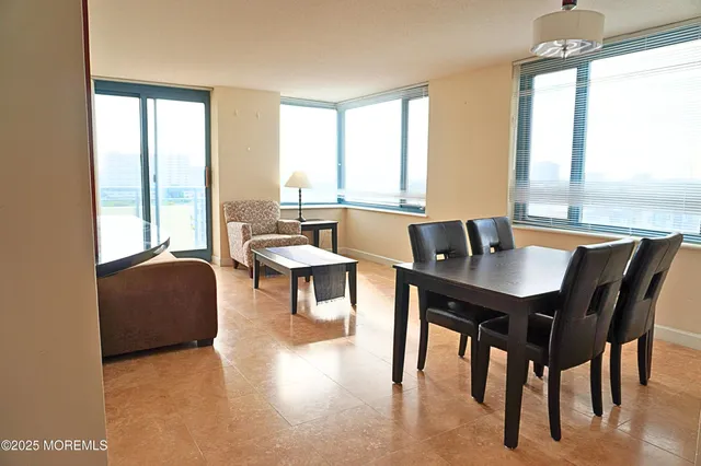 a dining room with furniture and window