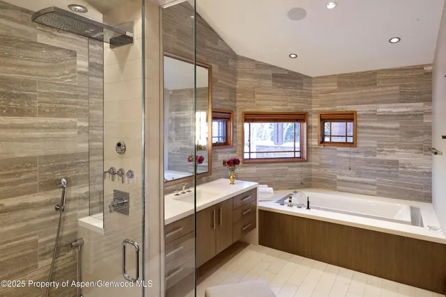 a large bathroom with a shower and a bath tub