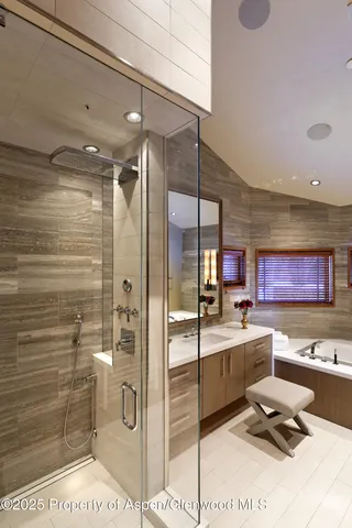 a bathroom with a double vanity sink mirror and bathtub