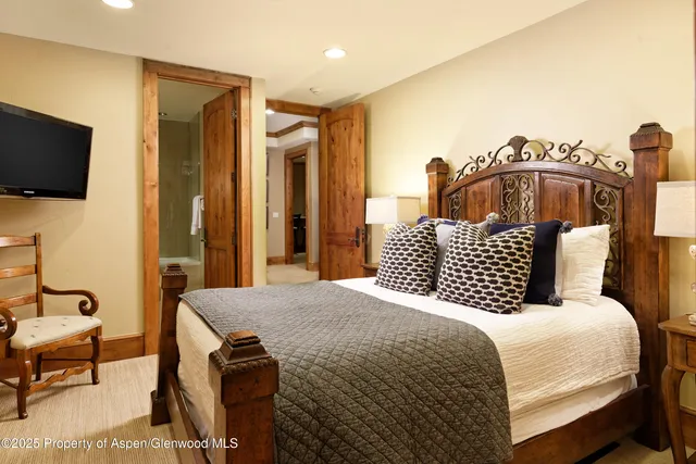 a bathroom with a granite countertop sink a toilet a mirror and bathtub