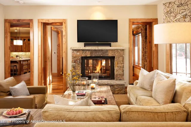 a living room with furniture fireplace and flat screen tv