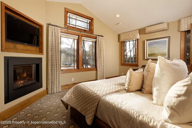 a bedroom with a balcony a bed and a television