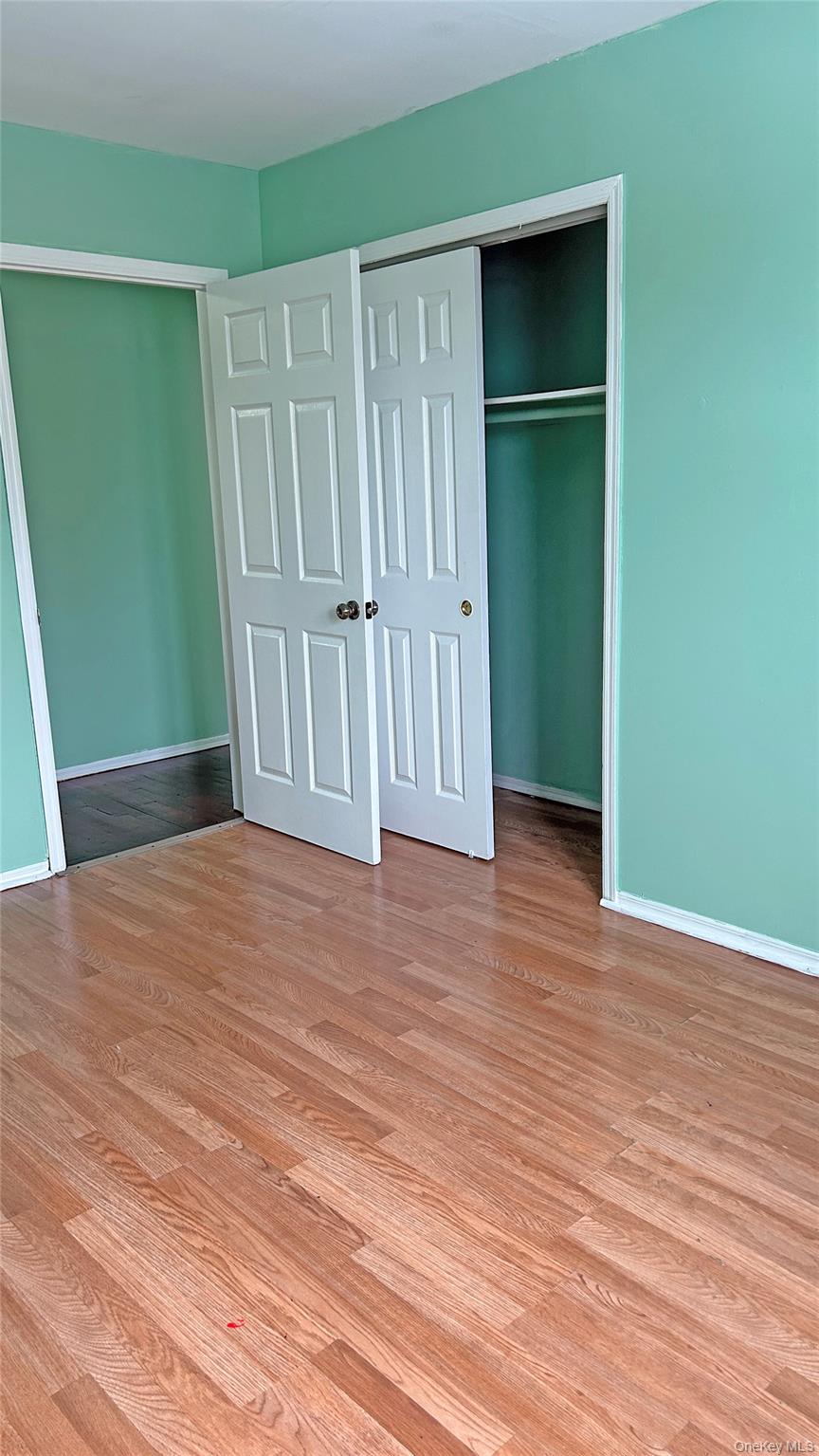 93-26 197th Street, Unit # 3 Queens, NY 11423 - Photo 7 of 14 Unfurnished bedroom featuring a closet and light wood-type flooring