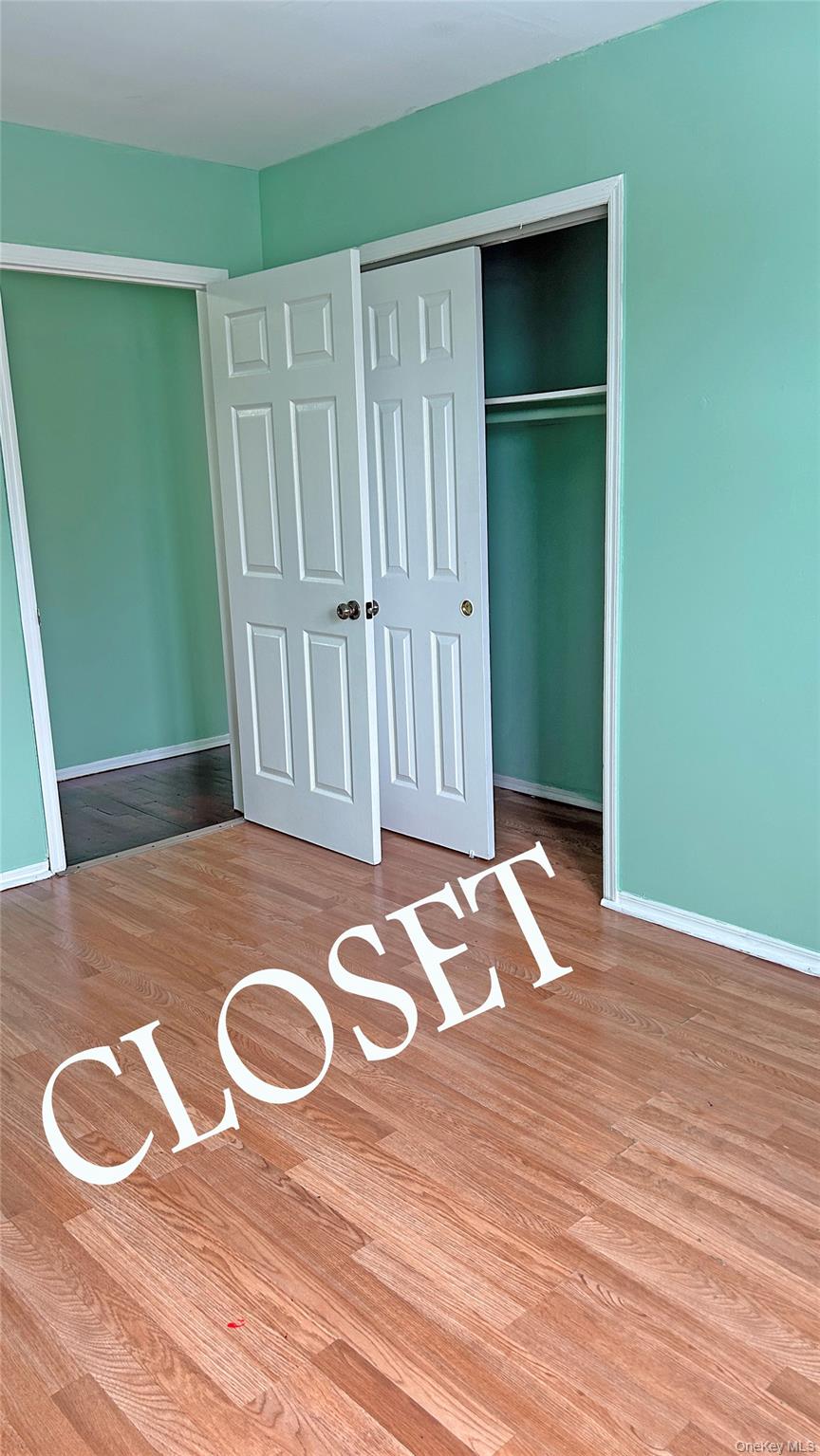 93-26 197th Street, Unit # 3 Queens, NY 11423 - Photo 8 of 14 Unfurnished bedroom featuring light wood-style flooring and a closet