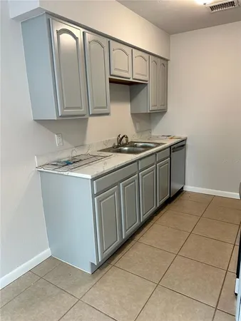 a kitchen with stainless steel appliances granite countertop a sink and a stove