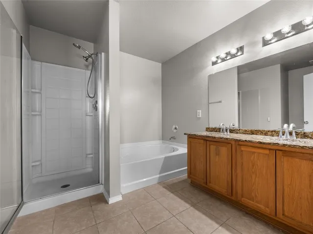 a bathroom with a tub a shower and a sink