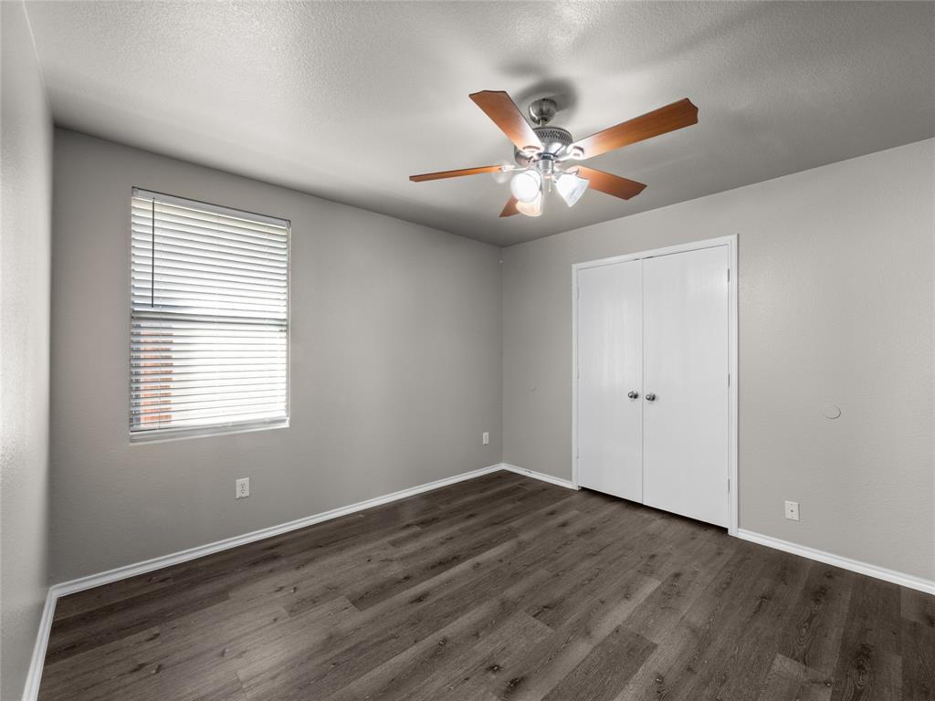 1021 Badger Run Lancaster, TX 75134 - Photo 16 of 25 a view of an empty room with window and wooden floor