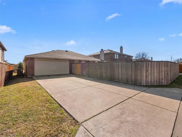 a view of a brick house with wooden fence