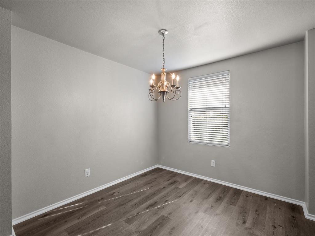 1021 Badger Run Lancaster, TX 75134 - Photo 4 of 25 wooden floor in an empty room with a window