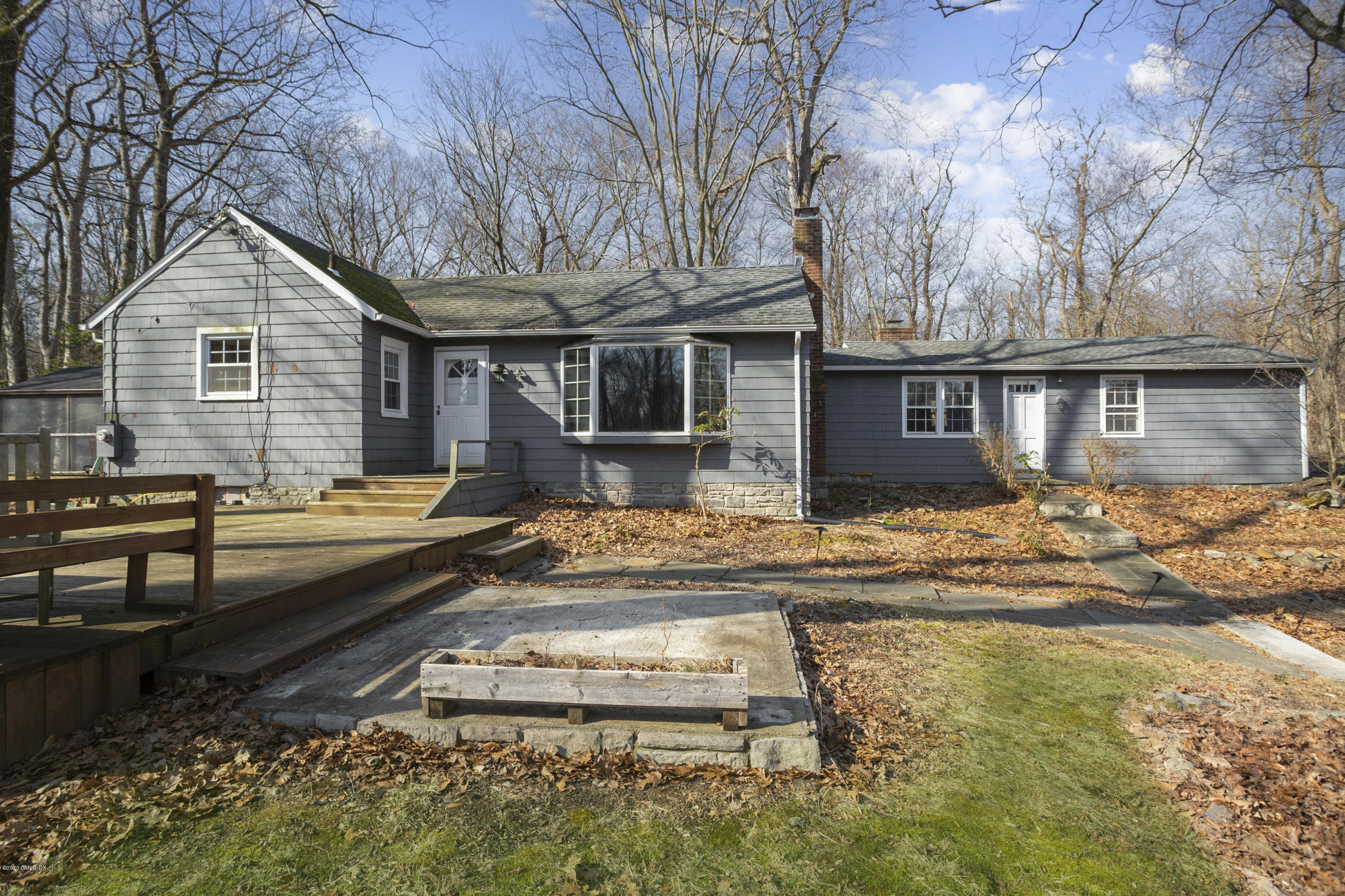 450 Riversville Road Greenwich, CT 06831 - Photo 1 of 14 a front view of house with yard outdoor seating and barbeque oven