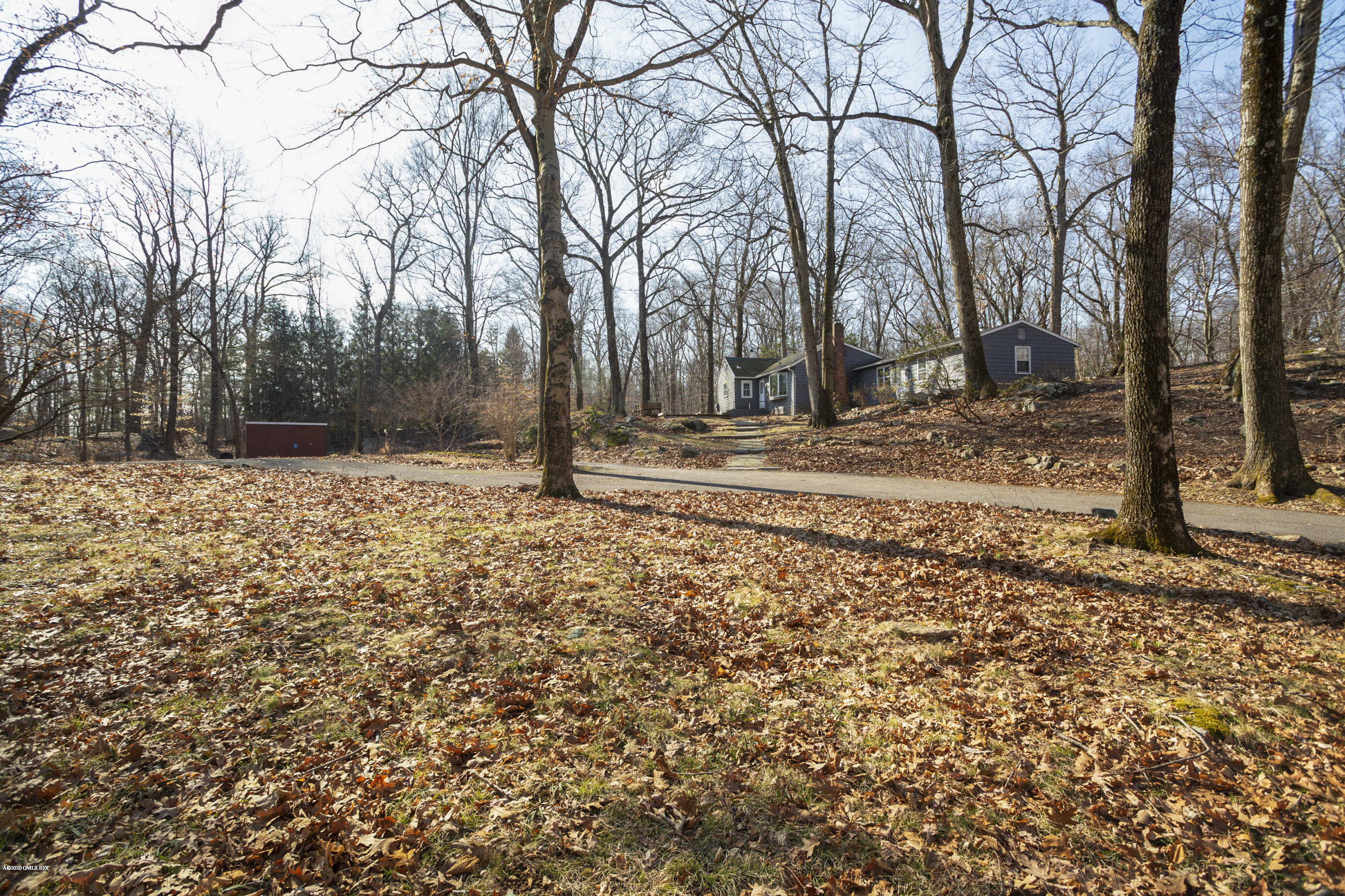 450 Riversville Road Greenwich, CT 06831 - Photo 2 of 14 a backyard of a house with trees