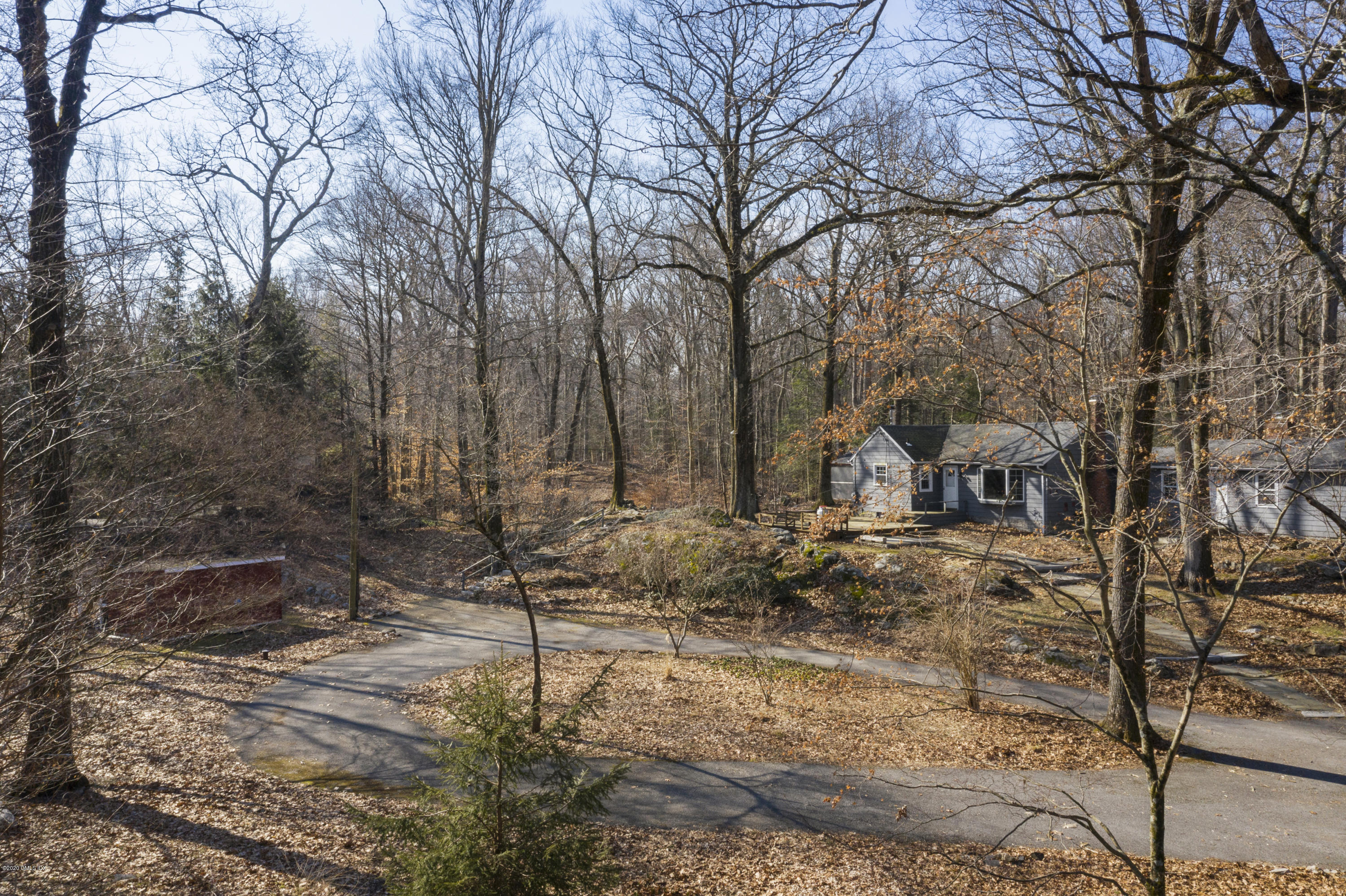 450 Riversville Road Greenwich, CT 06831 - Photo 3 of 14 a view of a yard covered with snow in the forest