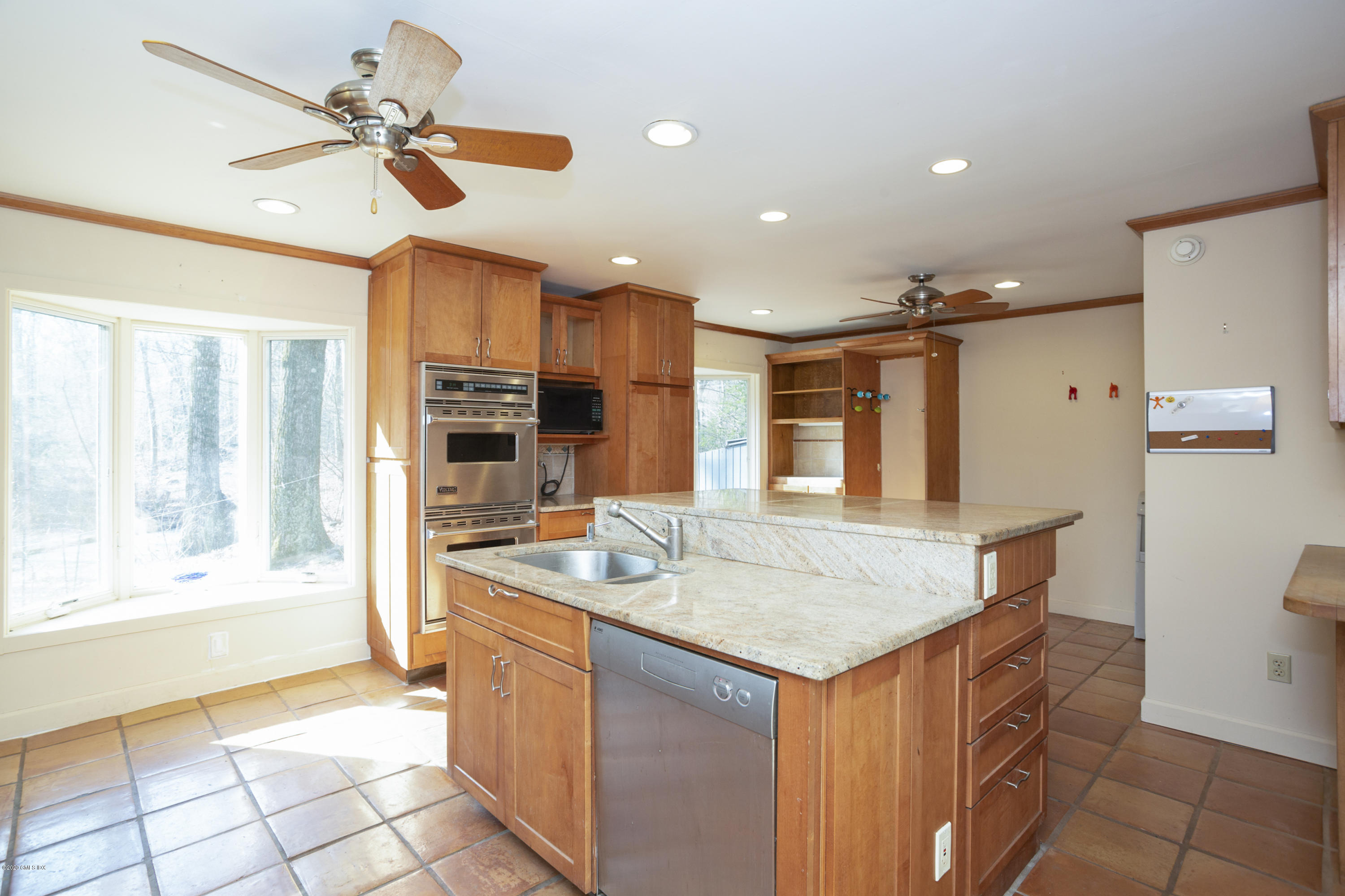 450 Riversville Road Greenwich, CT 06831 - Photo 5 of 14 a open kitchen with stainless steel appliances granite countertop a sink and a refrigerator