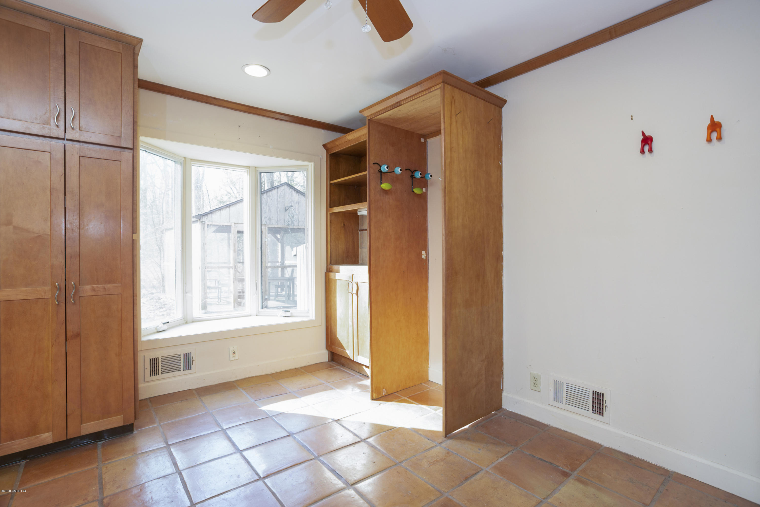 450 Riversville Road Greenwich, CT 06831 - Photo 6 of 14 a view of an entryway with wooden floor and cabinet