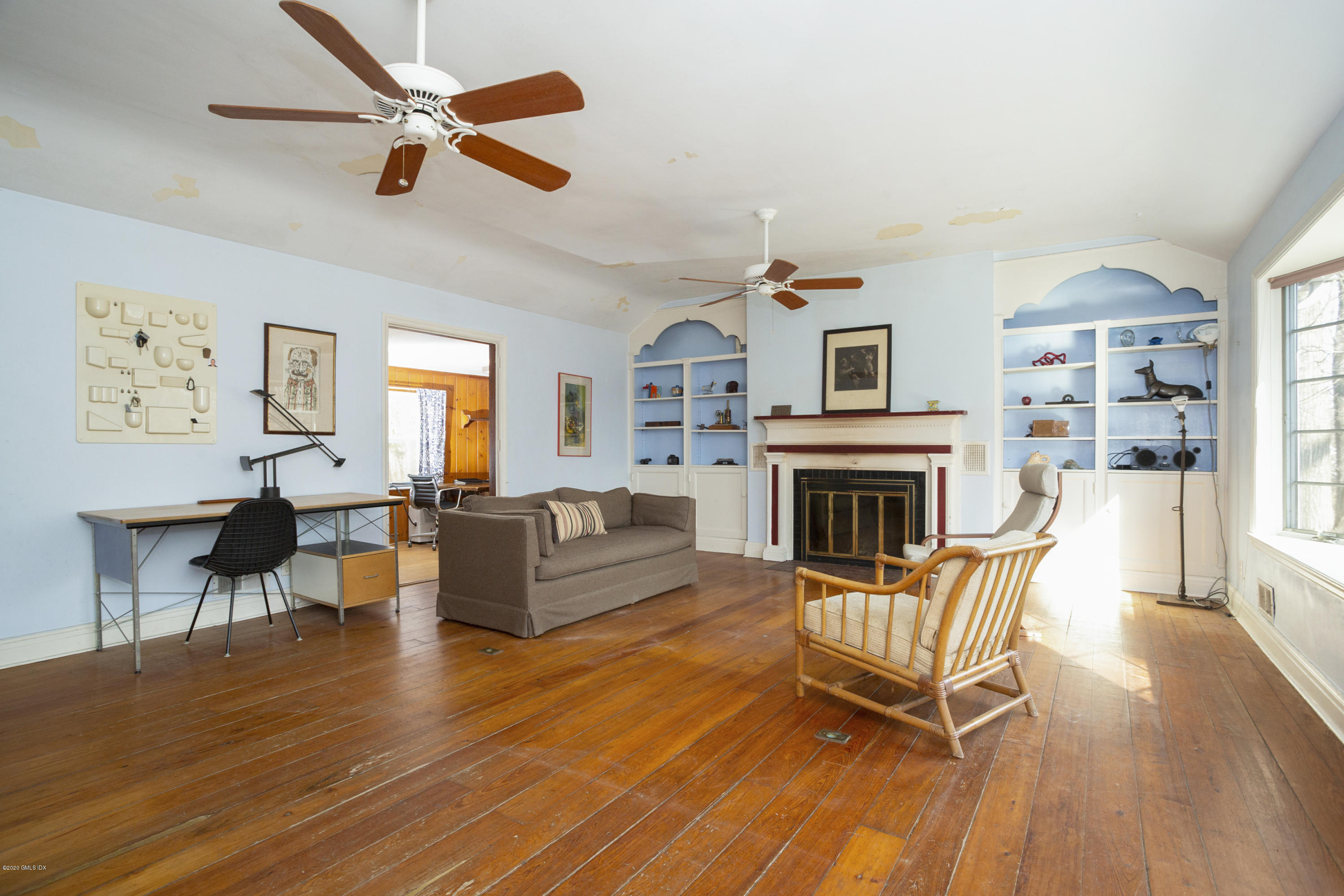 450 Riversville Road Greenwich, CT 06831 - Photo 8 of 14 a living room with furniture and a fireplace