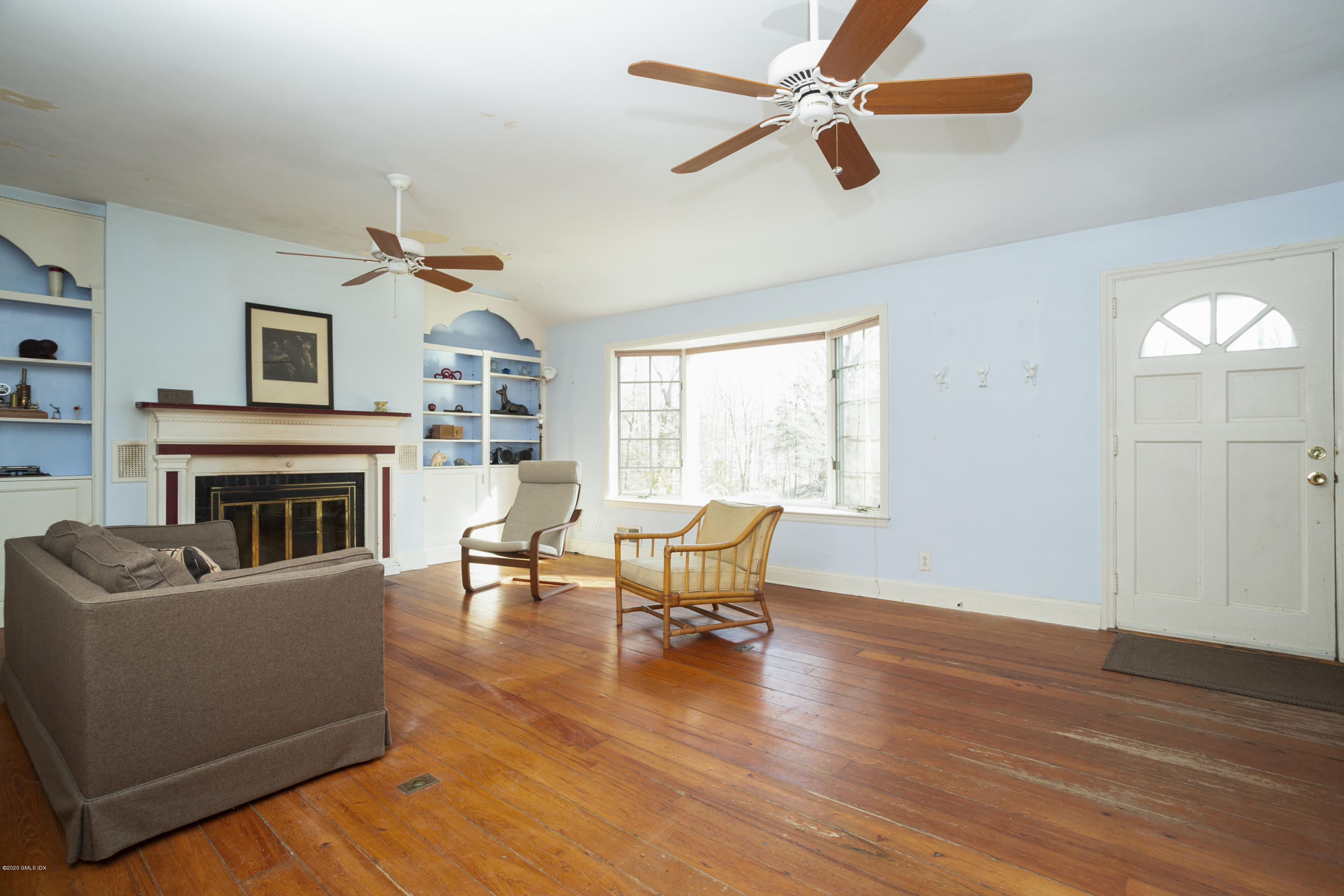 450 Riversville Road Greenwich, CT 06831 - Photo 9 of 14 a living room with furniture and a fireplace