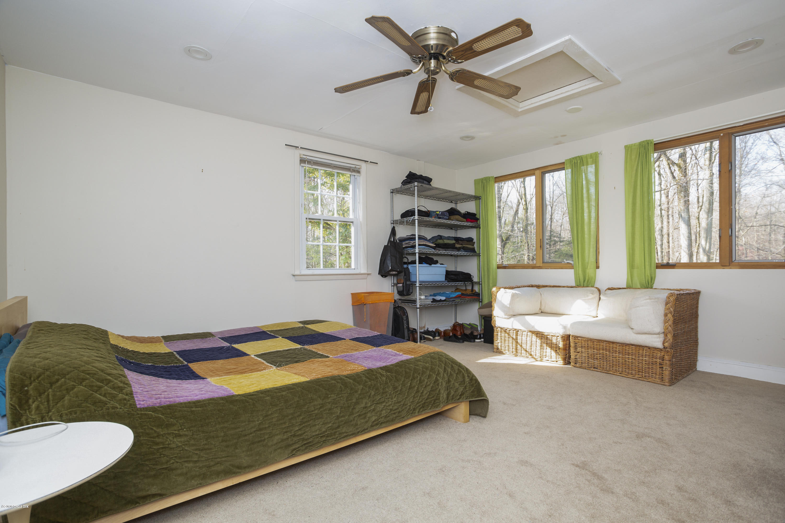 450 Riversville Road Greenwich, CT 06831 - Photo 10 of 14 a bedroom with a bed couch and window