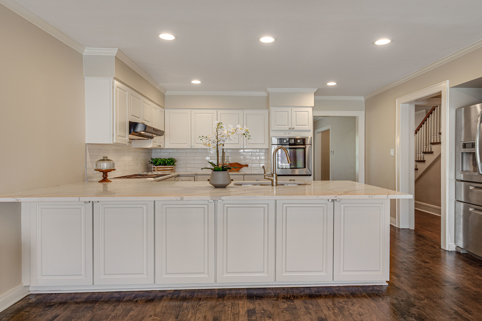 1417 Tower Road Winnetka, IL 60093 - Photo 14 of 39 a kitchen with stainless steel appliances granite countertop a refrigerator a sink dishwasher and white cabinets with wooden floor