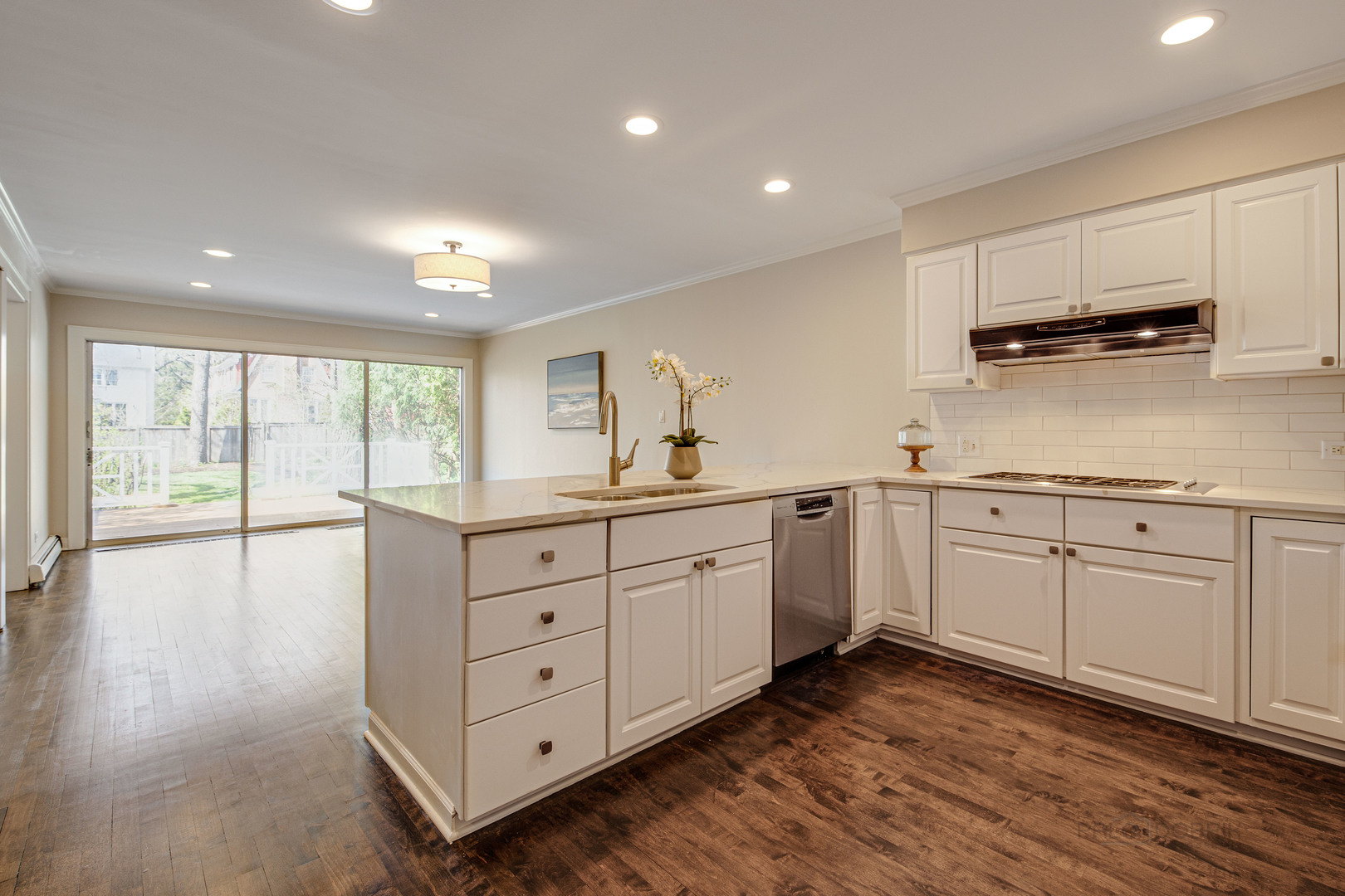 1417 Tower Road Winnetka, IL 60093 - Photo 15 of 39 a kitchen with white cabinets and wooden floors