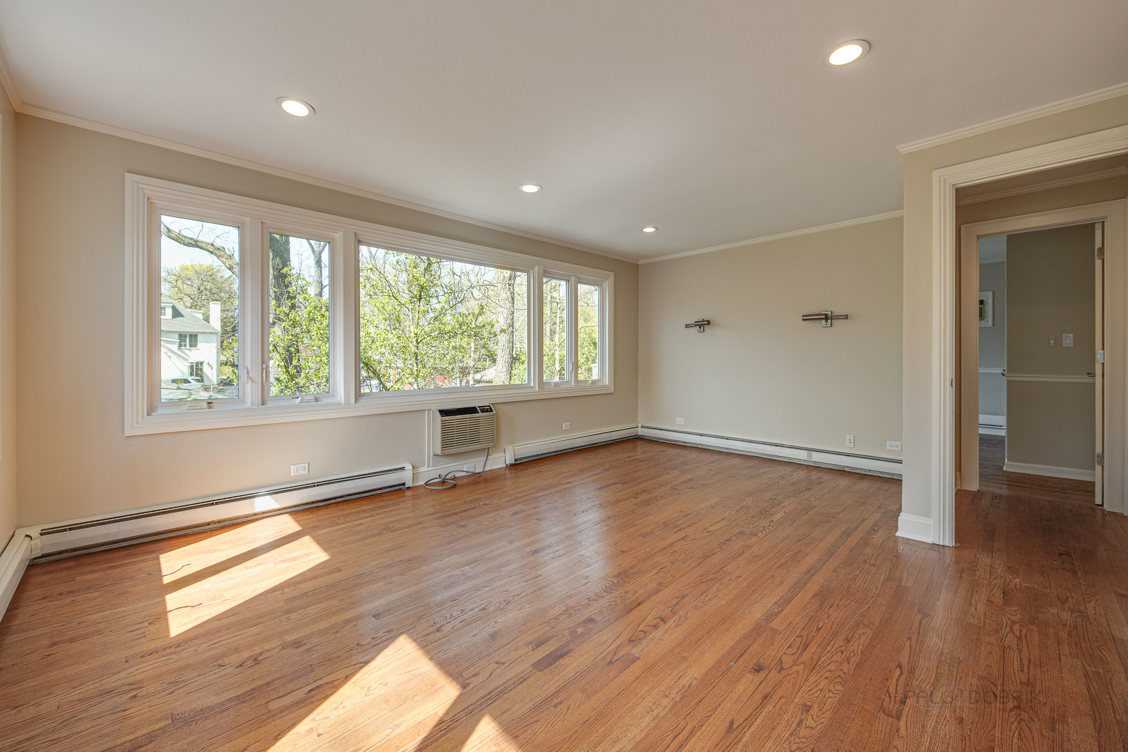 1417 Tower Road Winnetka, IL 60093 - Photo 19 of 39 an empty room with wooden floor and windows